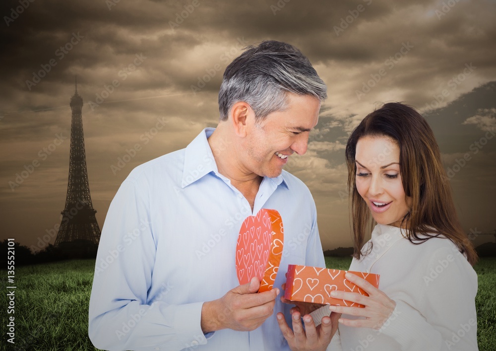 Man offering gift to woman with Eiffel tower in background