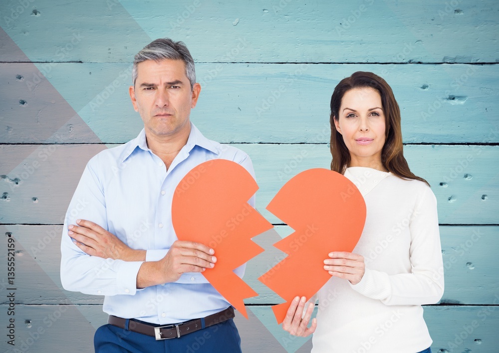 Depressed couple holding broken heart