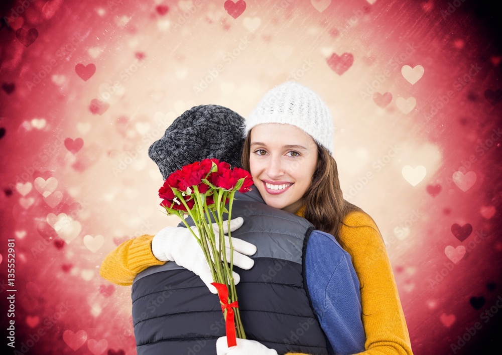 Woman holding bunch of roses embracing man