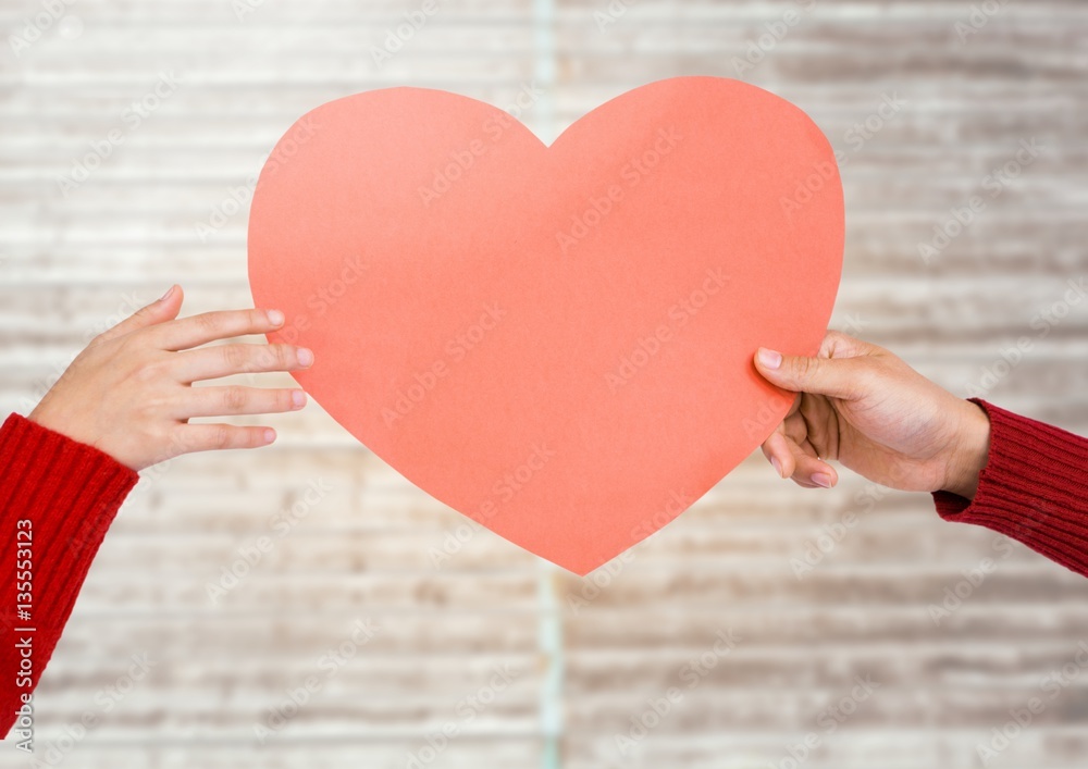 Hands of couple holding heart shape