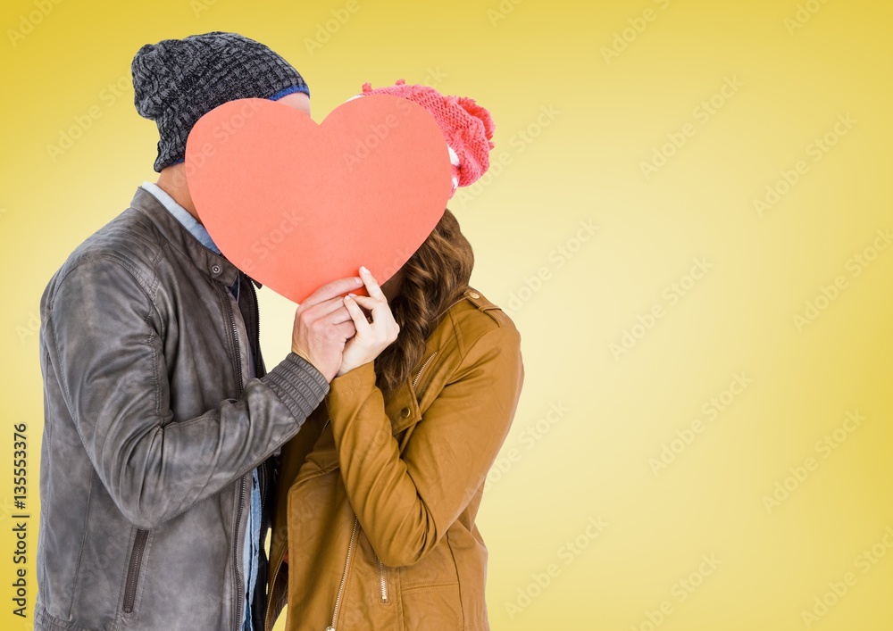 Romantic couple holding heart shape and kissing each other