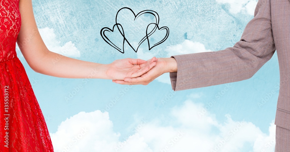 Couple with linked hands with drawn hearts in background