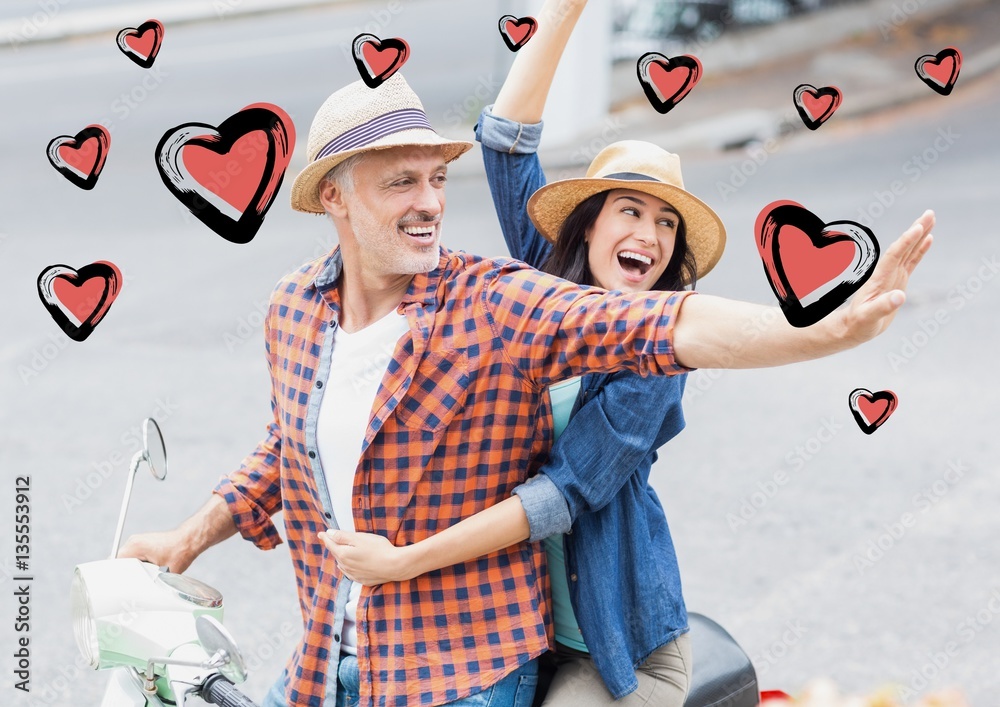 Happy couple on scooter in street with hearts shapes