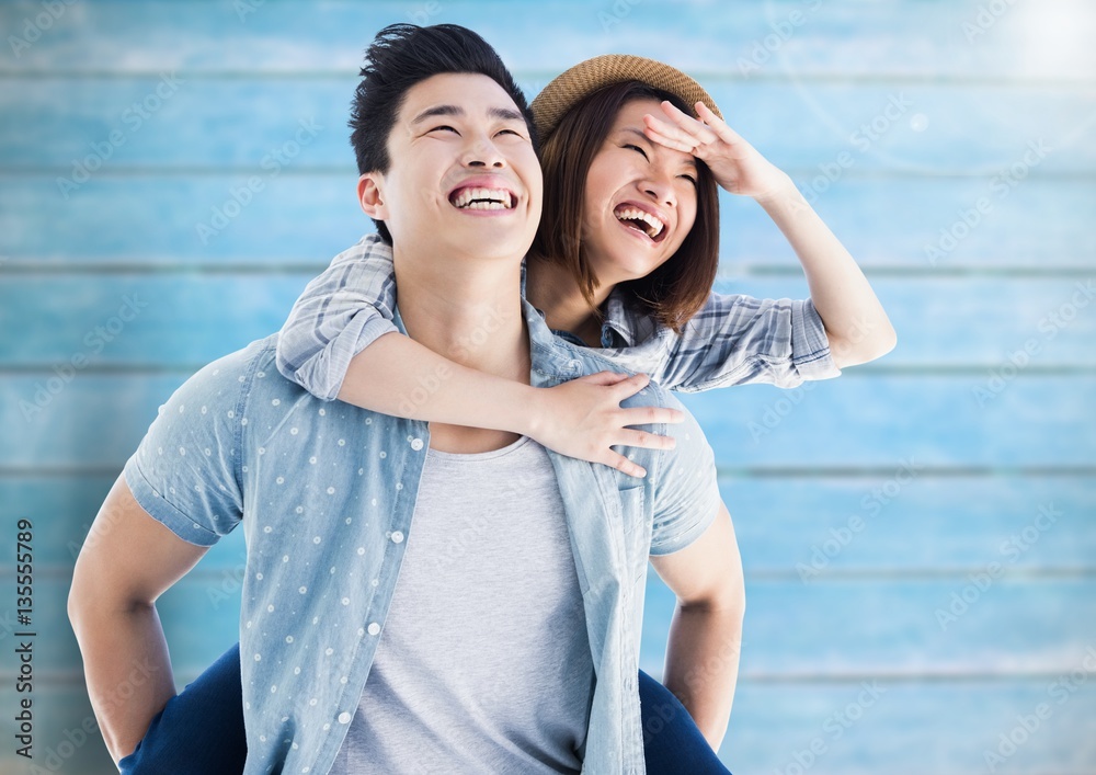 Happy man giving woman piggyback