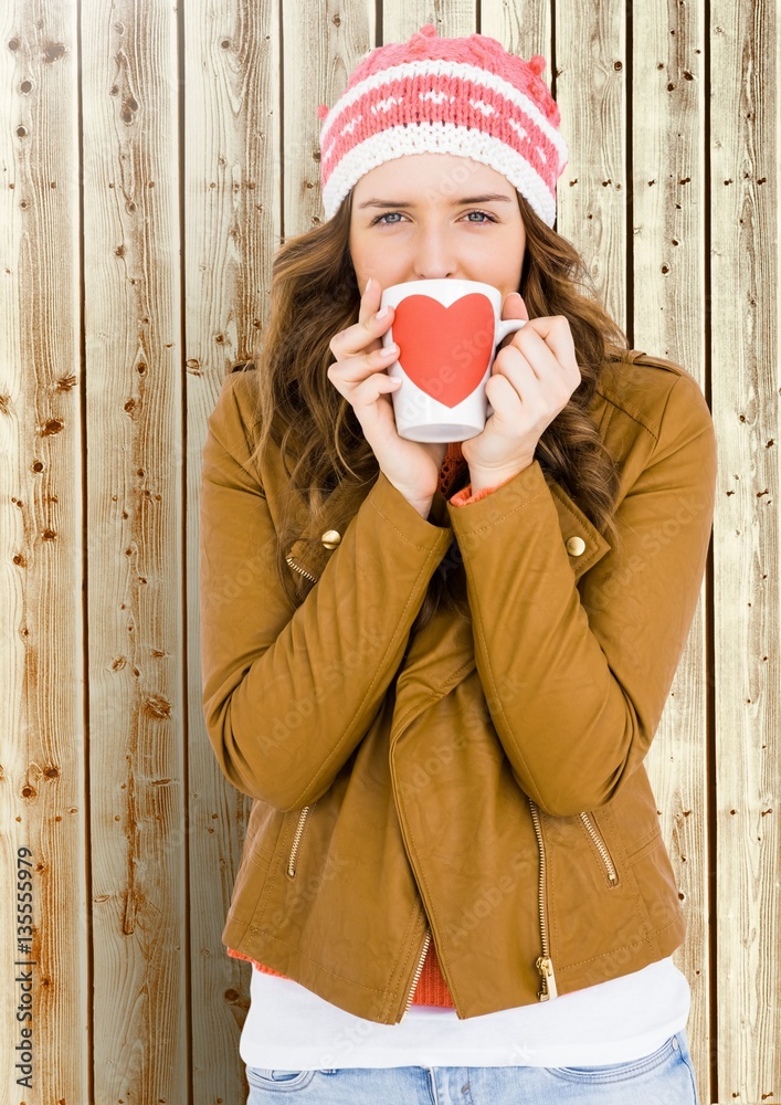 Woman holding a mug with a heart shape on it