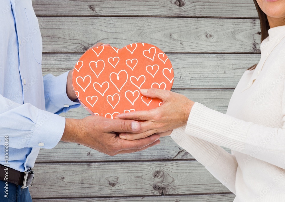 Couple holding heart shape box