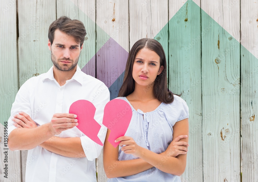 Depressed couple holding broken heart