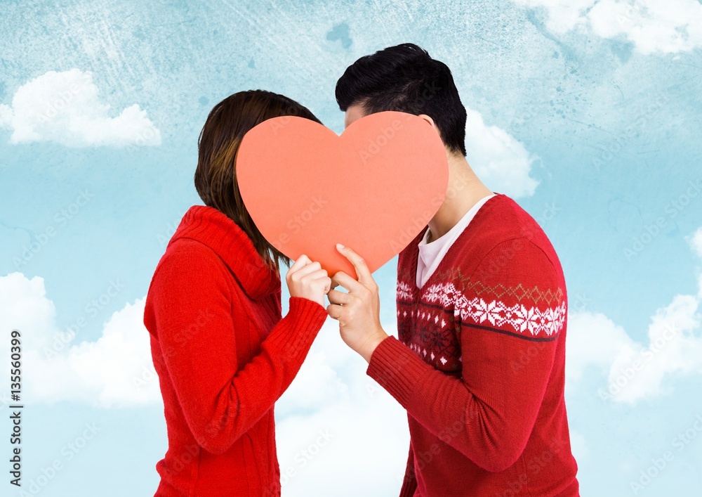 Romantic couple holding heart shape and kissing each other