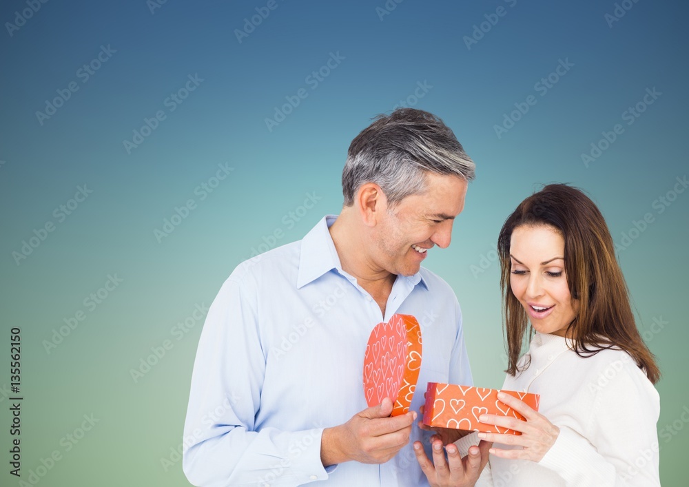 Couple holding heart shaped gift box 