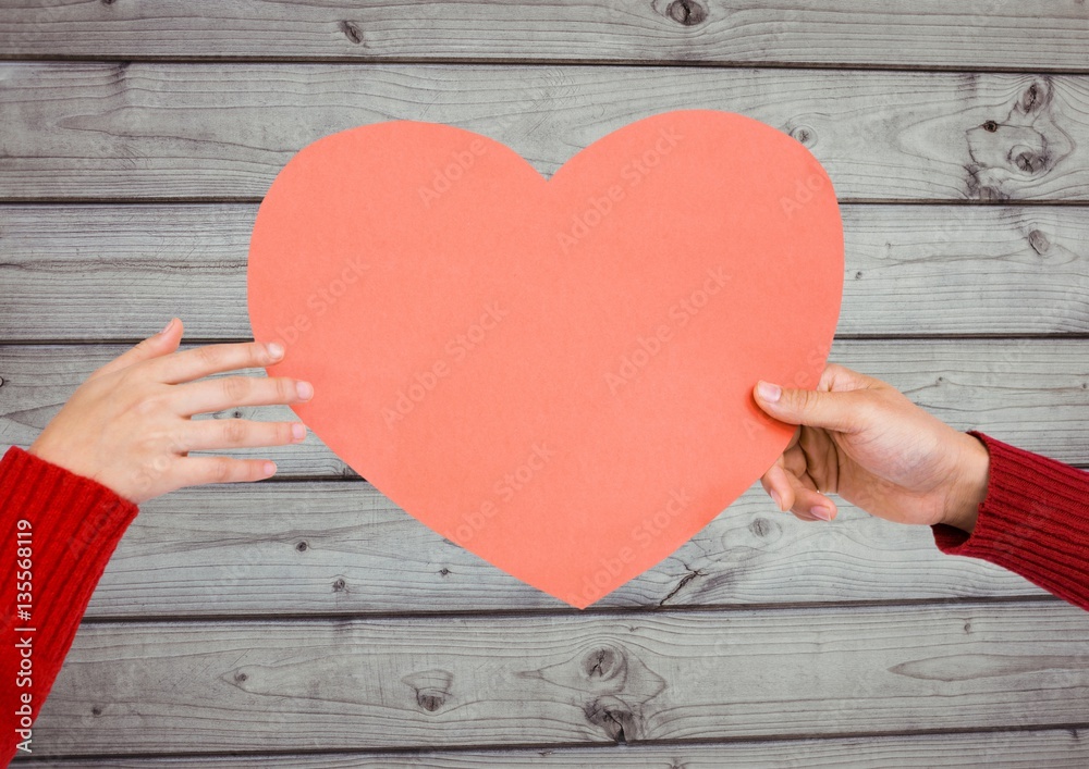 Hands of couple holding a heart