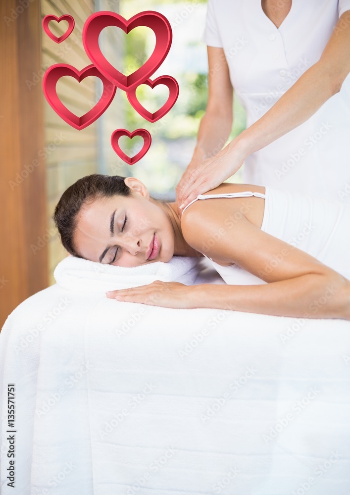 Masseur giving massage to woman at spa