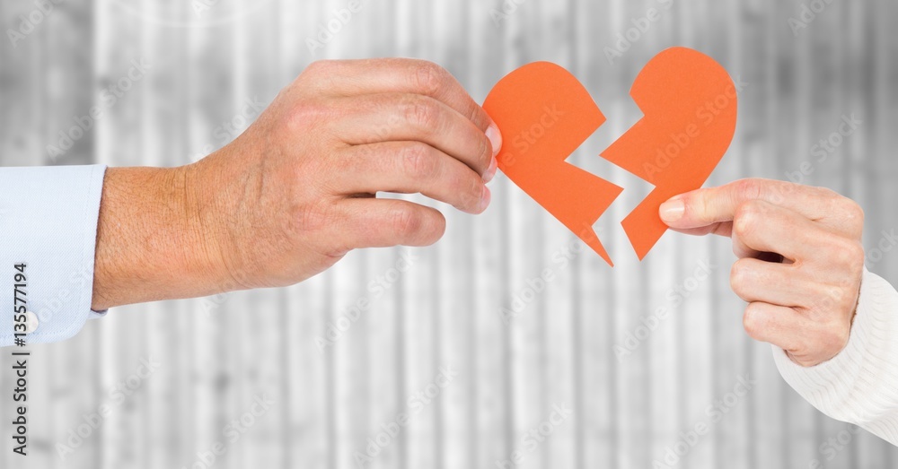 Hands of couple holding a broken heart