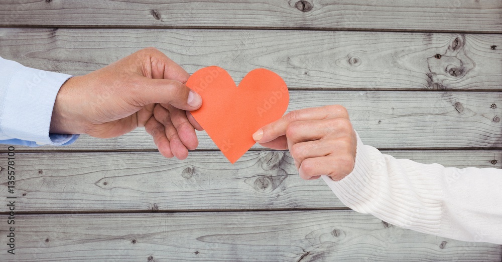 Hands of couple holding a heart