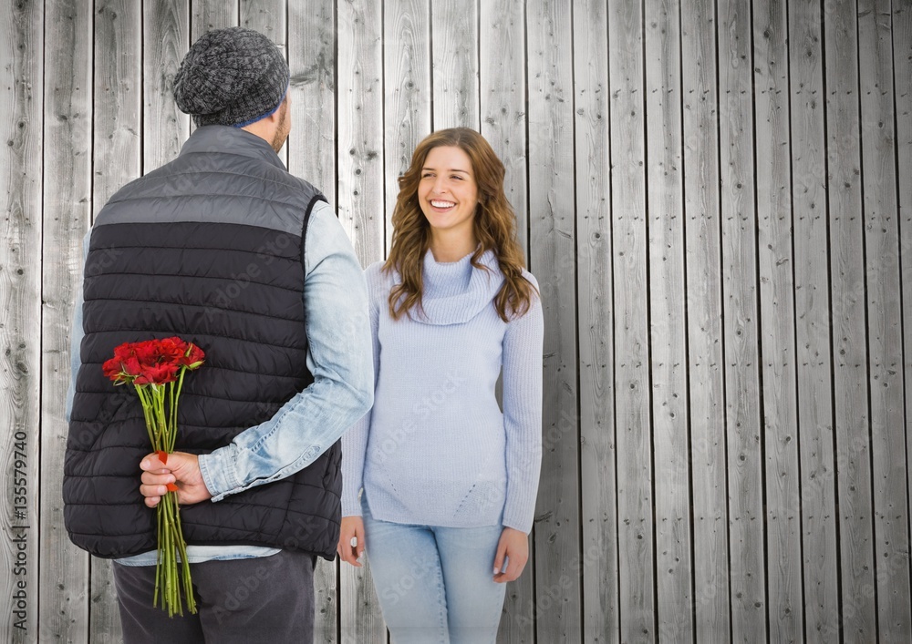 Man hiding flowers behind his back