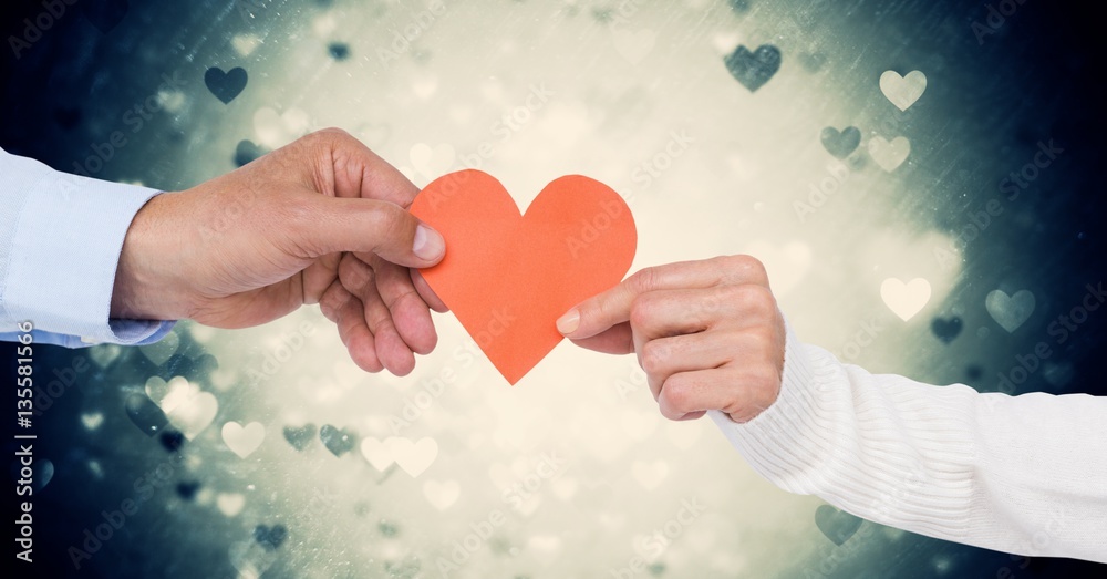 Hands of couple holding a heart