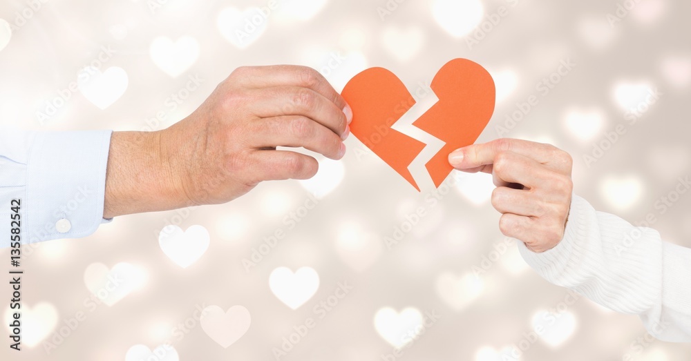 Hands of couple holding a broken heart