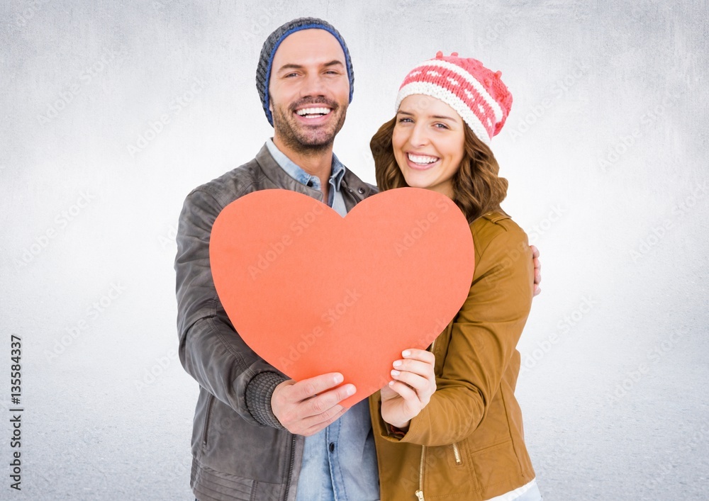 Smiling couple holding a heart