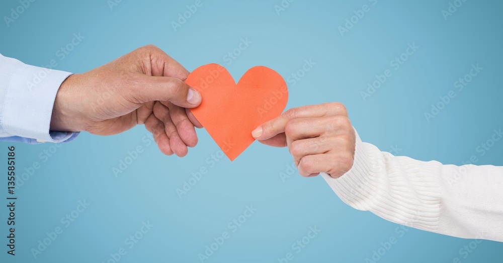 Hands of couple holding a heart