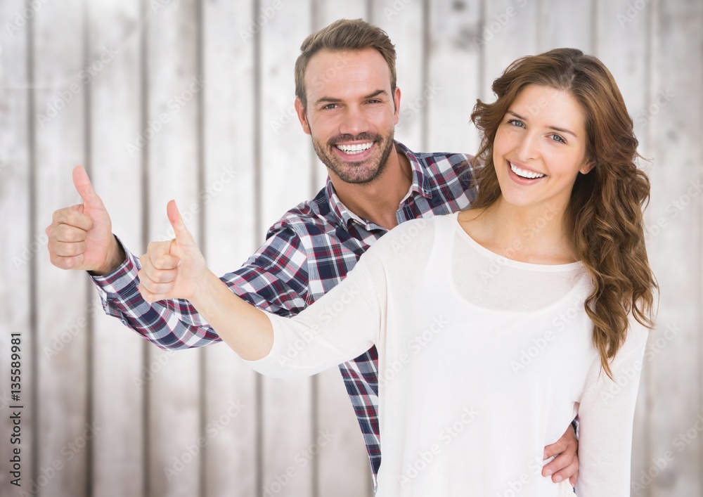 Happy couple giving thumbs up 