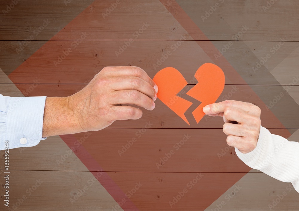 Hands of couple holding a broken heart