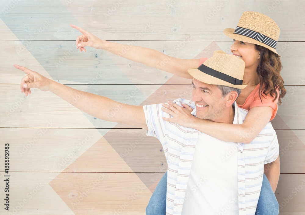 Loving couple pointing against wooden background