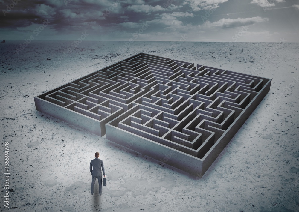 Businessman standing in front of a maze