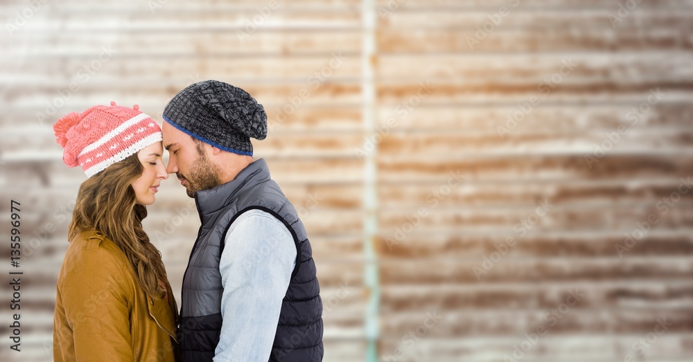 Couple embracing each other against wooden background