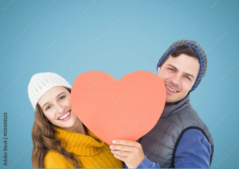 Happy couple holding a red heart