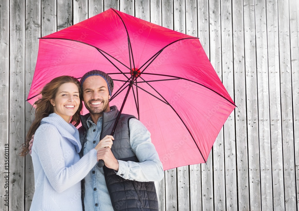 Composite image of couple with umbrella