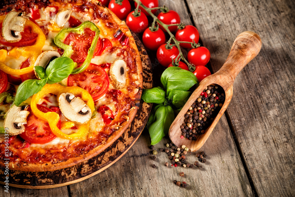 Pizza with ingredients served on wood