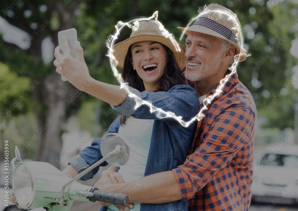 Happy couple taking selfie on scooter