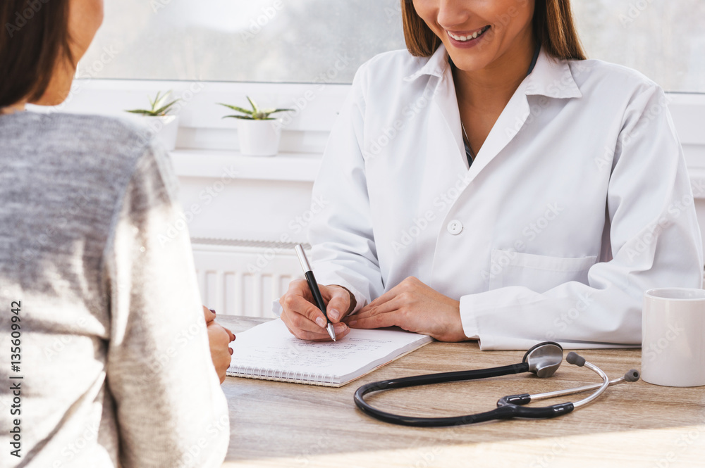 Teen girl having consultation with beautiful female doctor.