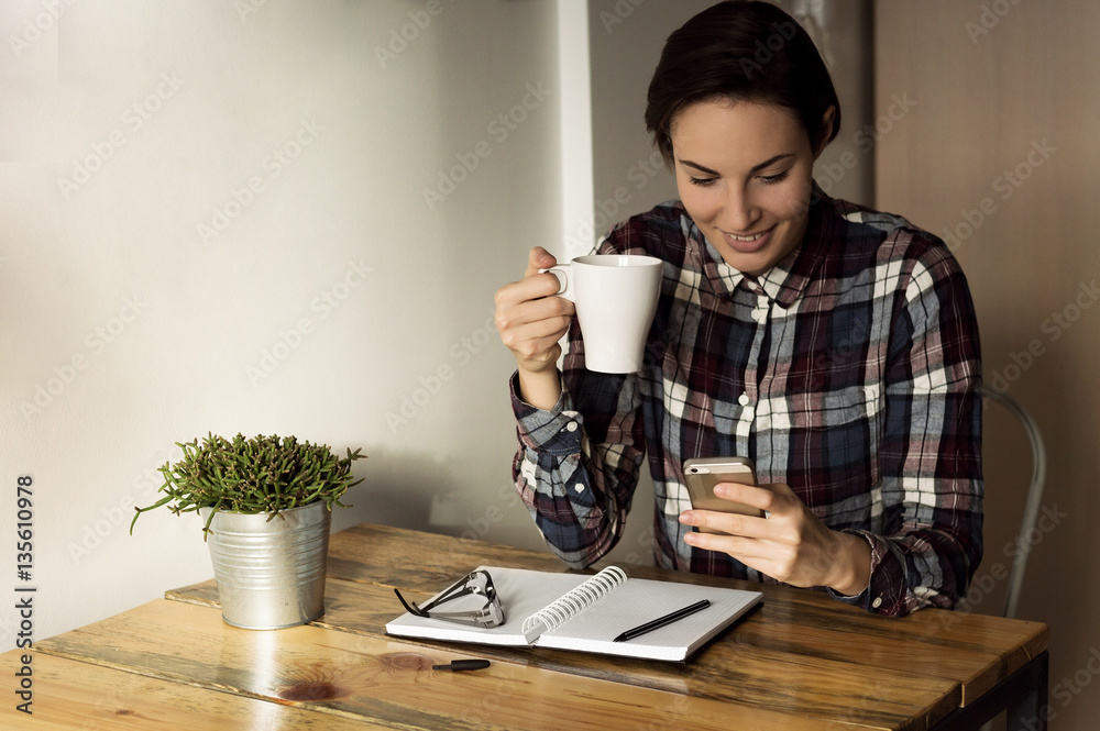 Woman drinking coffee to get some energy for working overtime