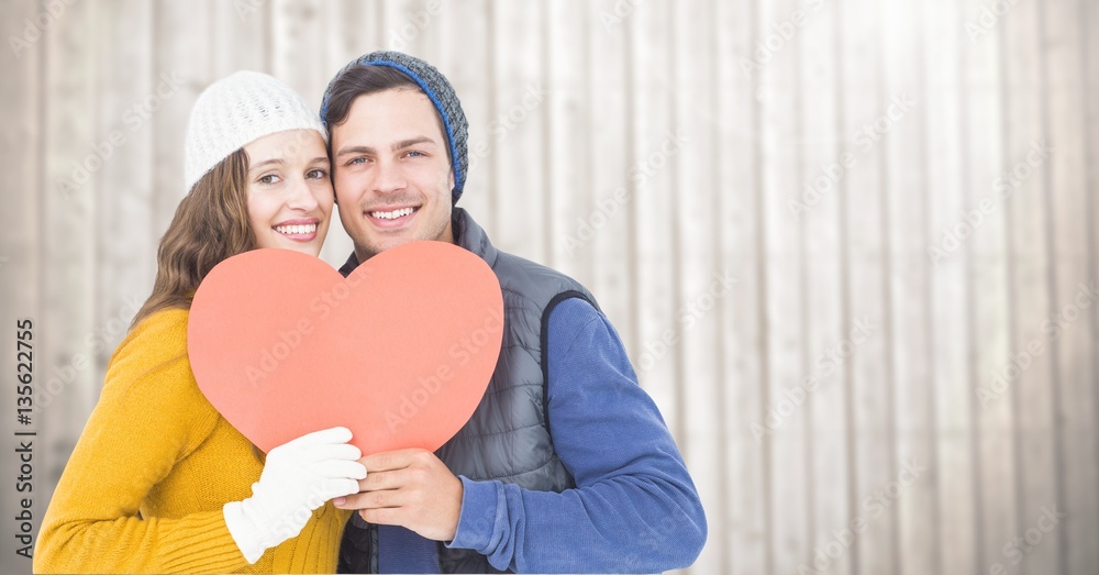 Portrait of happy couple holding hearts