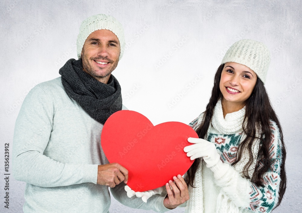 Portrait of smiling couple holding red hearts