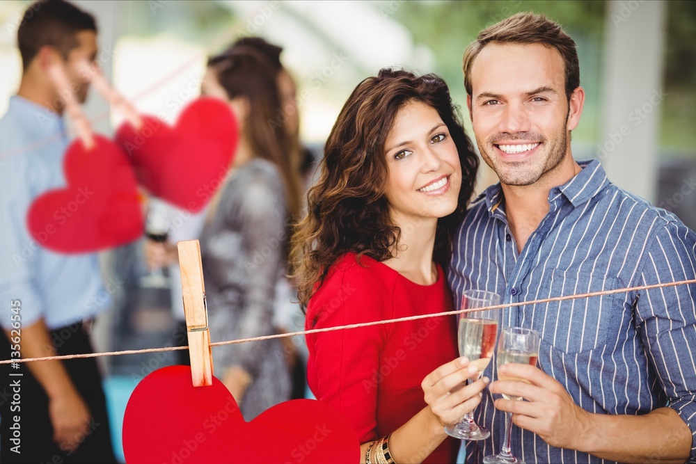 Romantic couple standing with a glasses of champagne