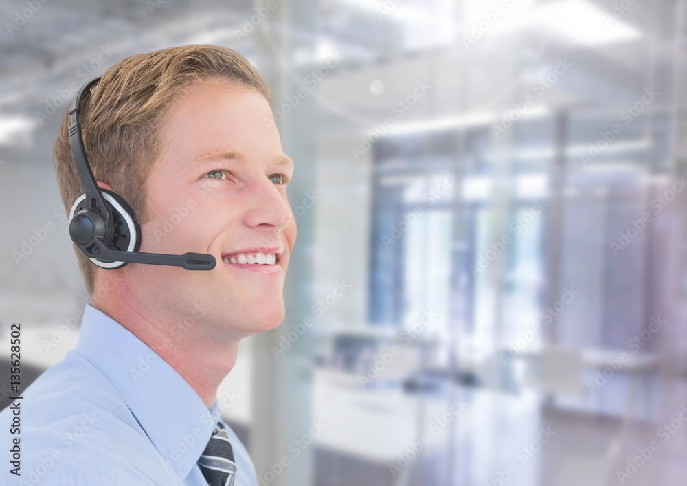 Smiling businessman with headset in office