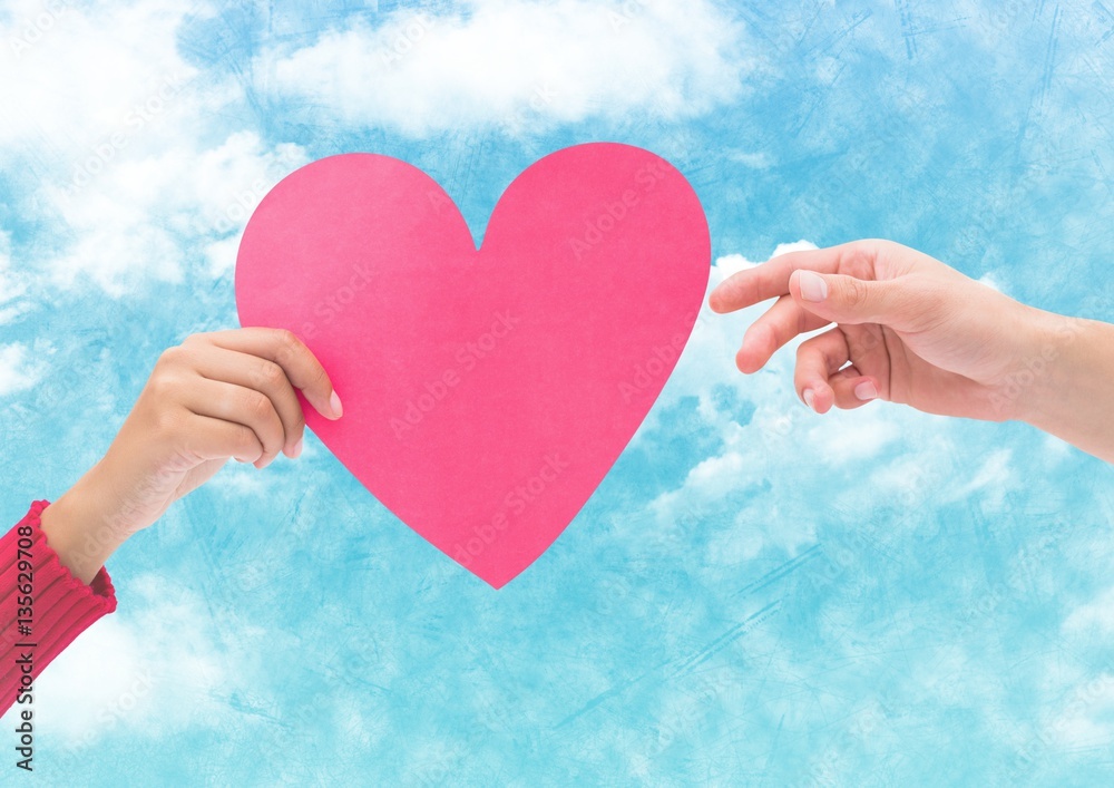 Hand on couple holding pink hearts