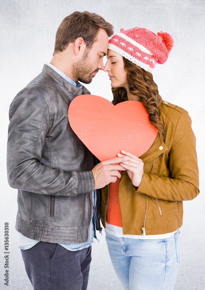 Romantic couple with face to face holding heart