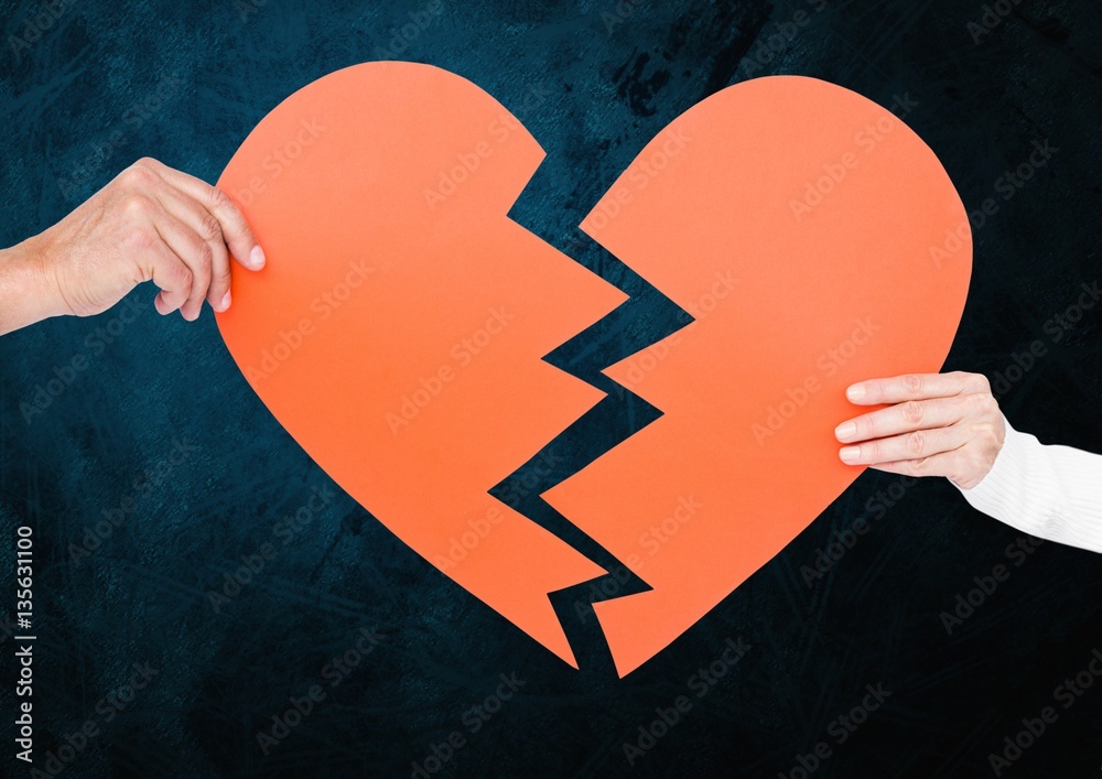 Hand of couple holding broken hearts