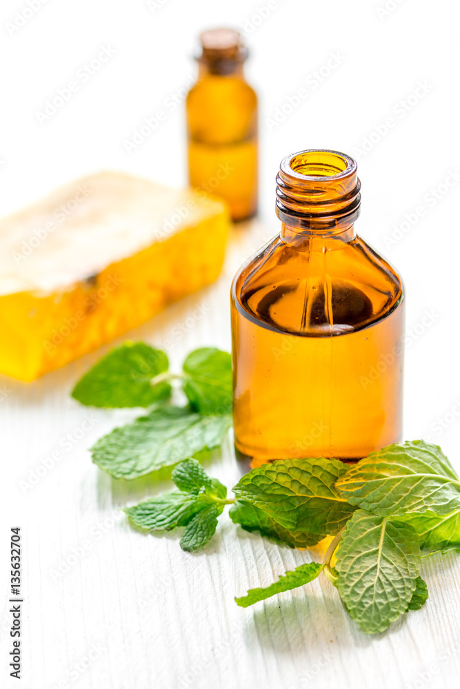 organic cosmetics with herbal extracts of mint on wooden background