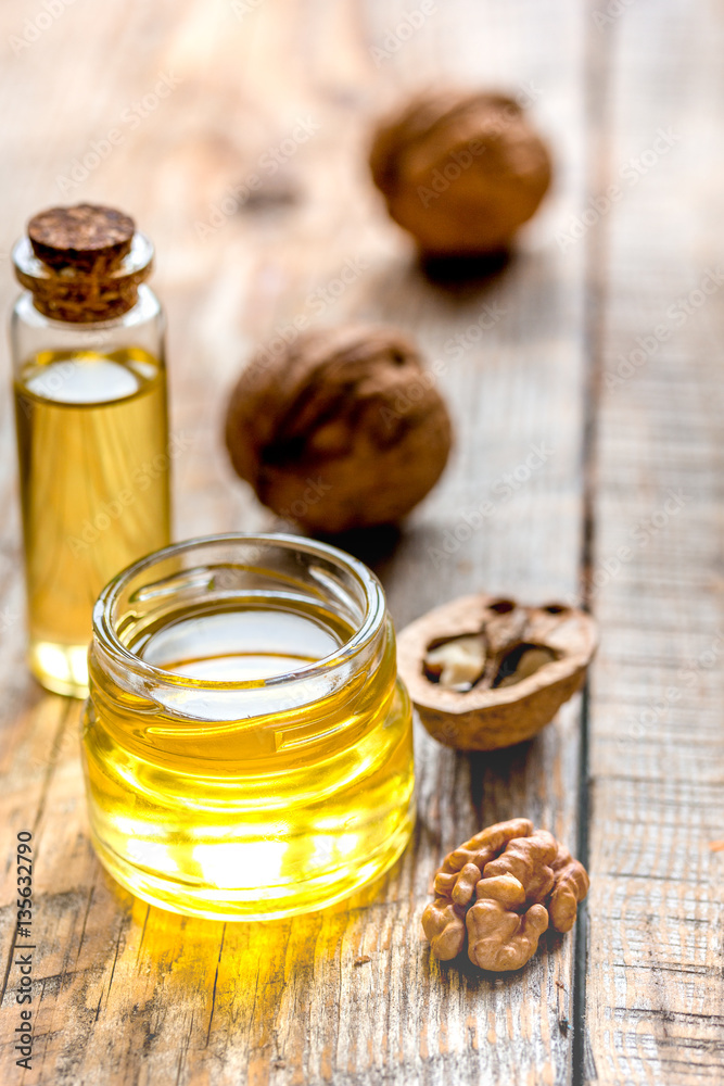 cosmetic and therapeutic walnut oil on wooden background