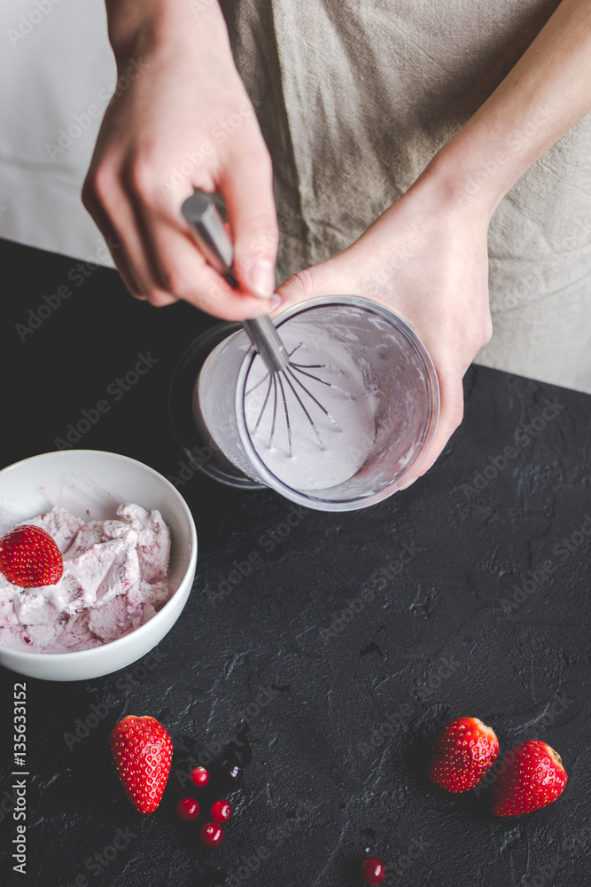 organic ice cream homemade process on dark background with hands