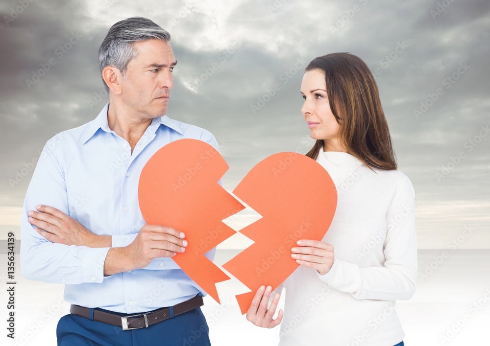 Mature couple holding a broken heart