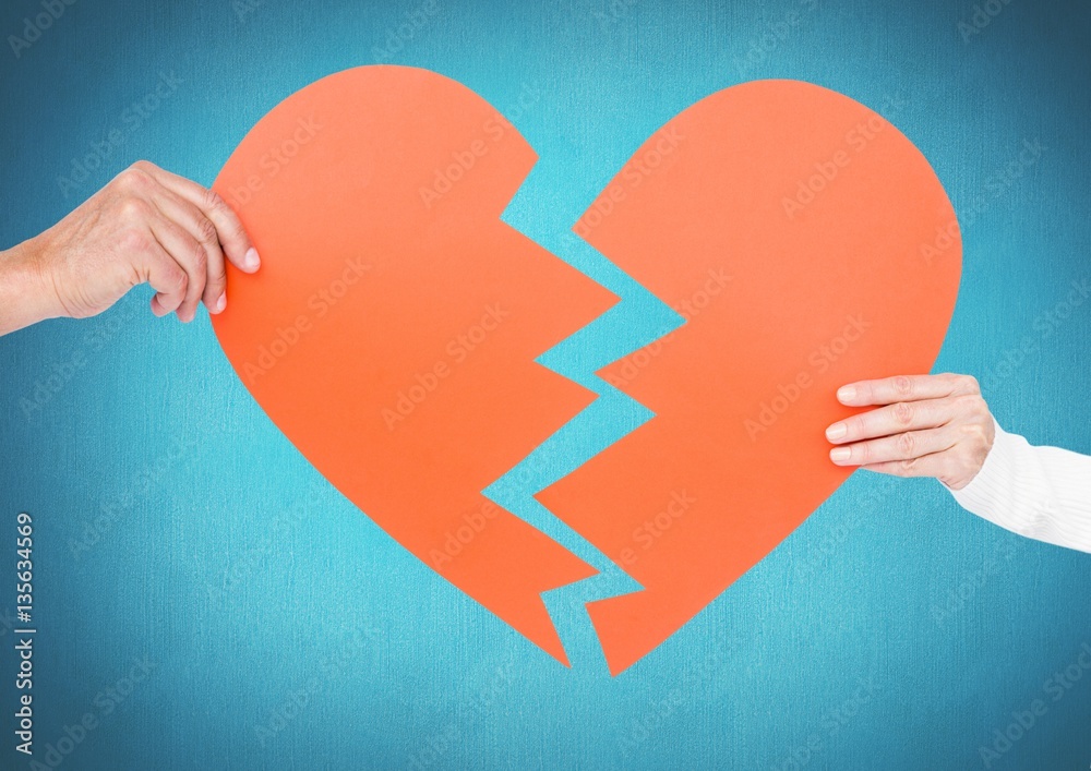 Hands of couple holding broken heart