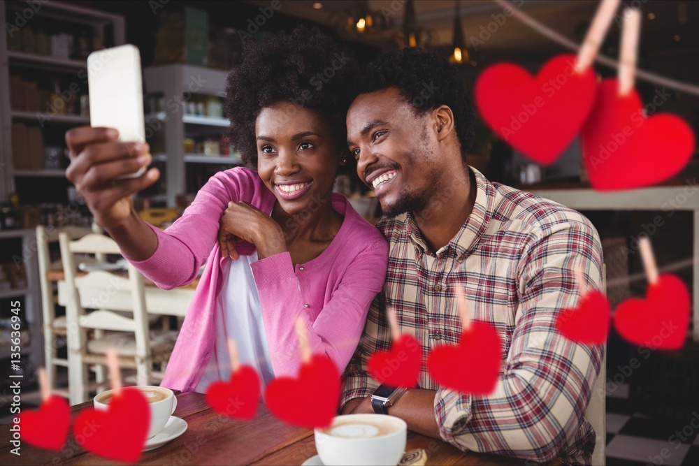 Happy couple taking selfie on mobile phone