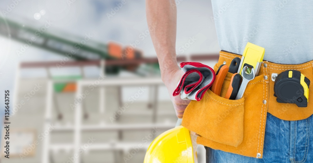 Mid section of construction man with tools