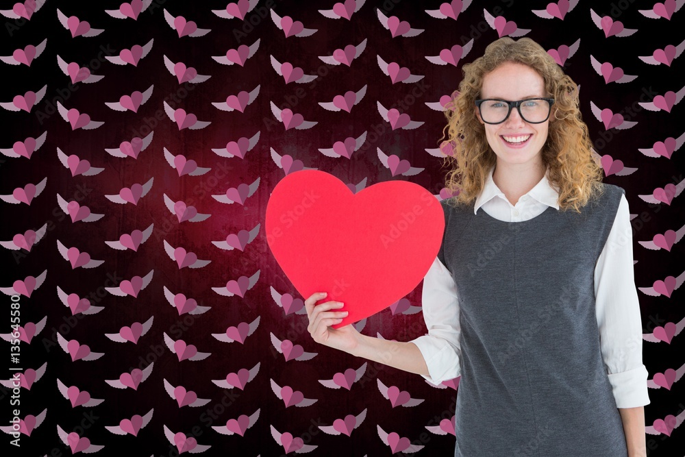 Composite image of nerd woman holding red heart