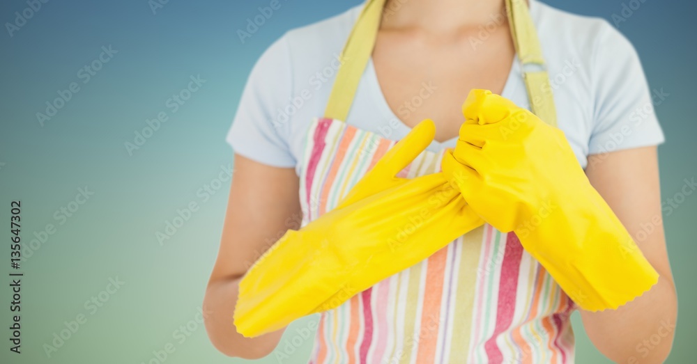 Female cleaner wearing apron and rubber gloves