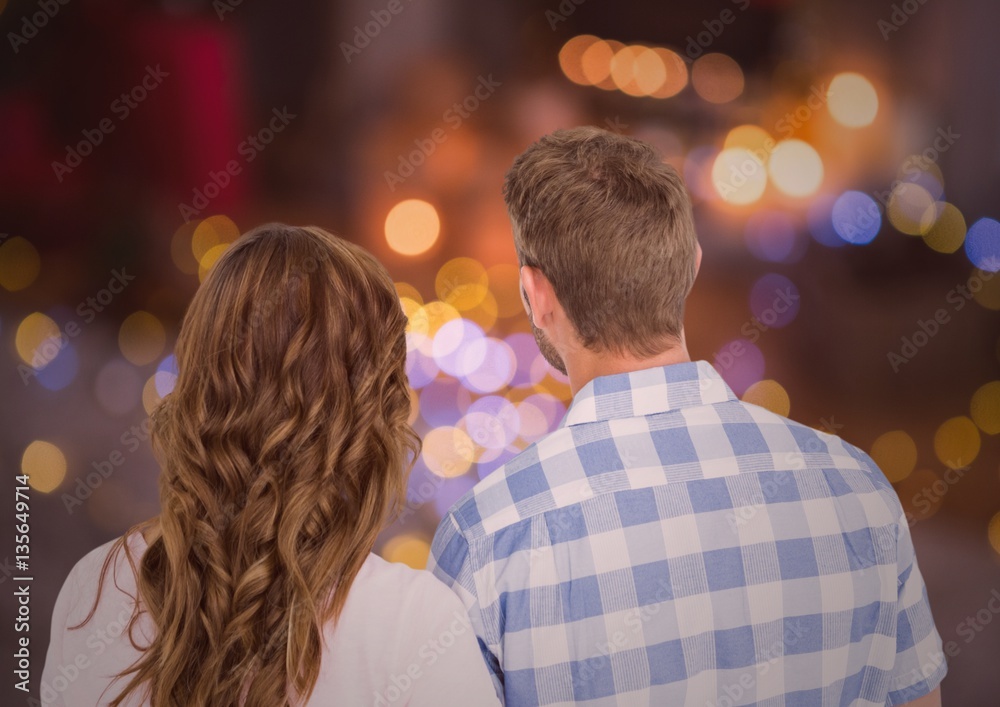 Rearview of couple looking at night bokeh